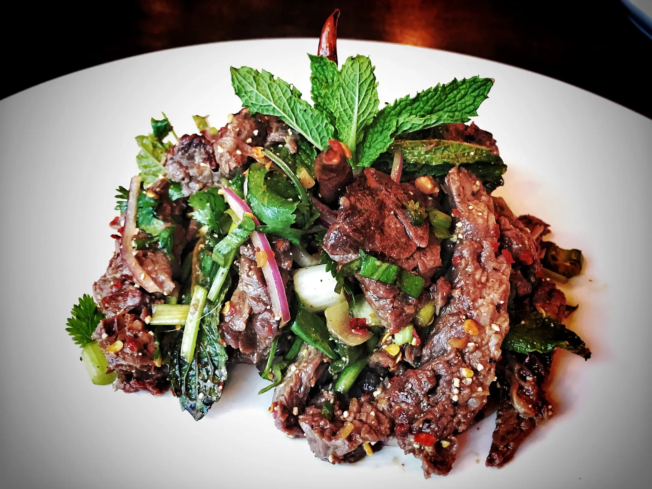 Close up shot of Nam Tok Nue salad.