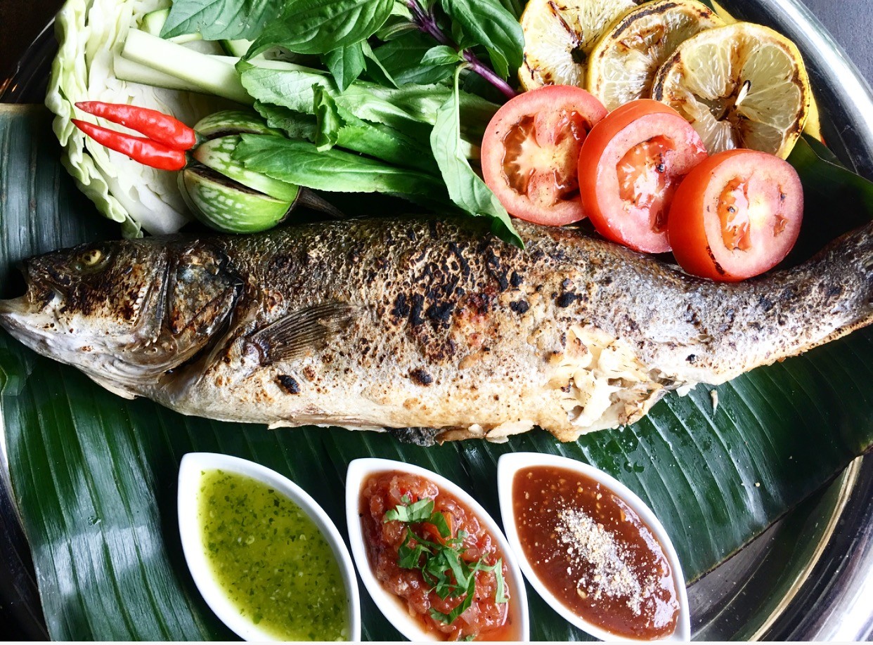 Grilled fish of the day with an assortment of grilled vegetables and several dipping sauces.